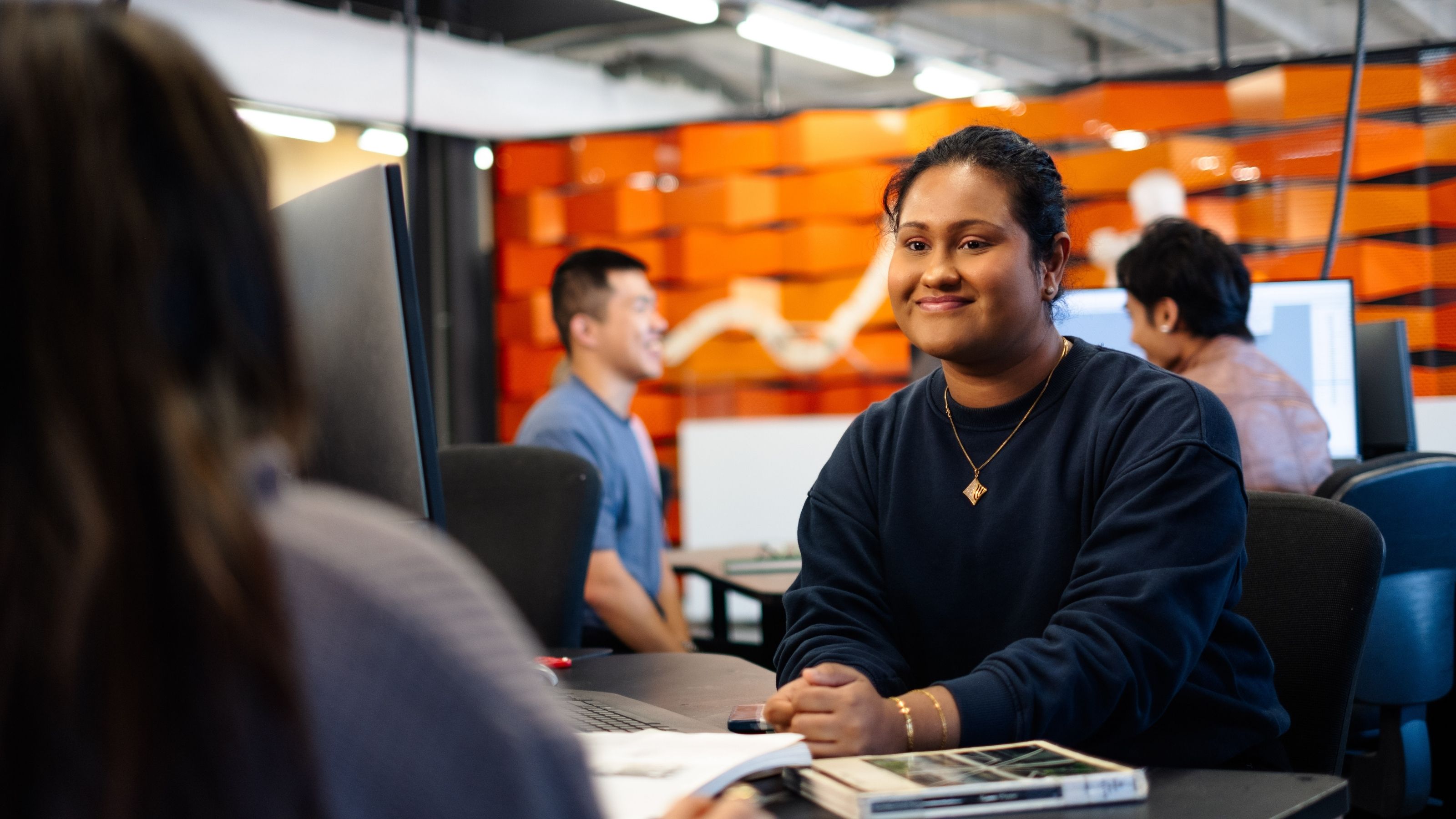An international student seated in a room with other students at Te Aro campus