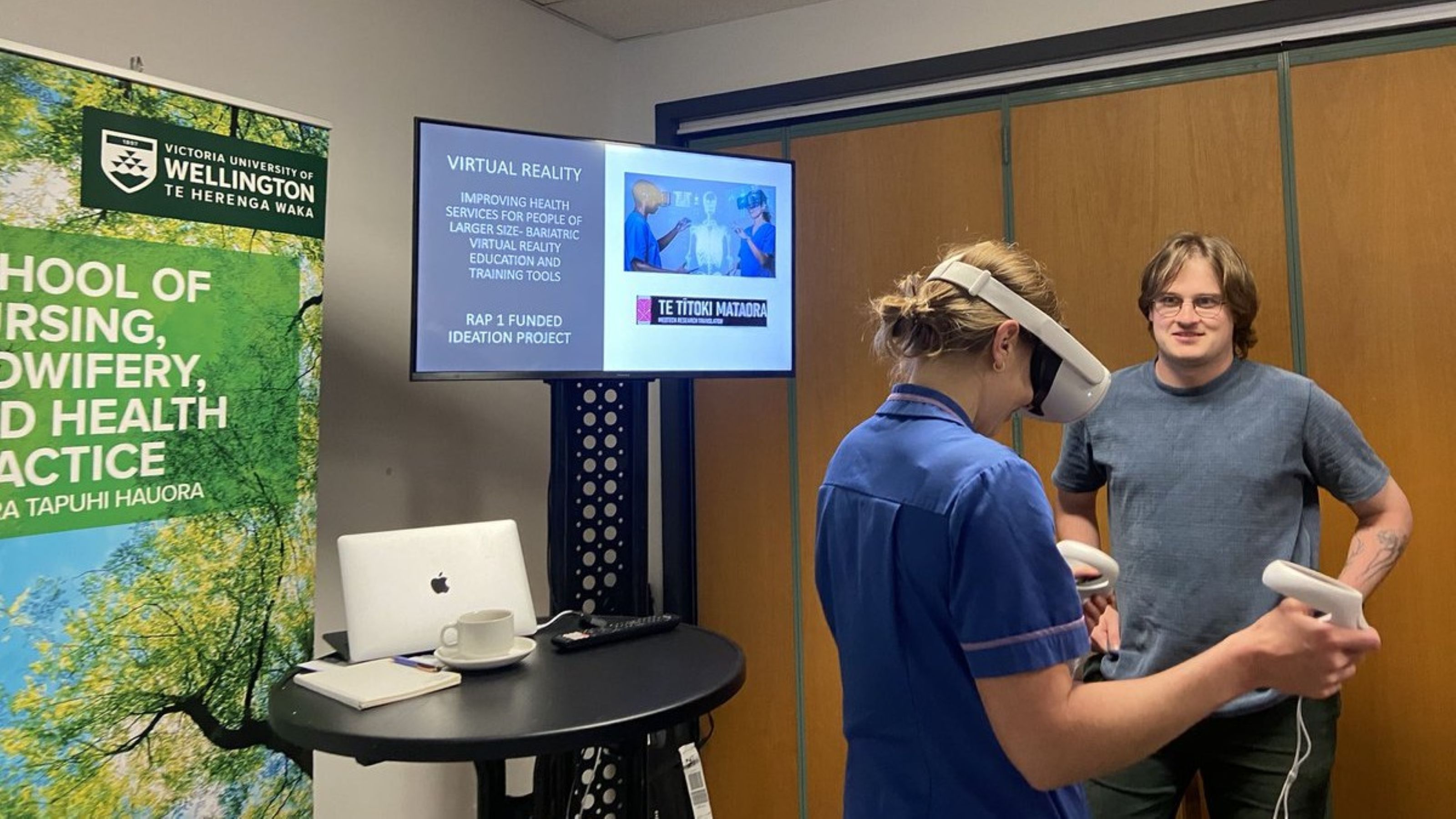 Two people using virtual reality googles in a project demonstration.