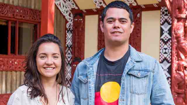 Ataria Sharman and Alan Hunt stand outside the marae at Victoria University.