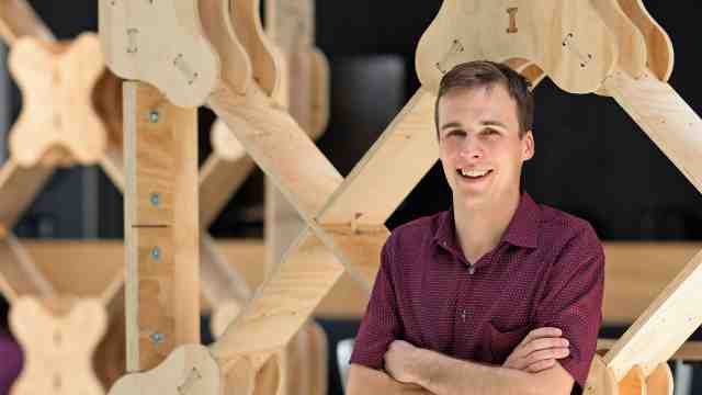 Student Ged Finch standing in front of prefab design.