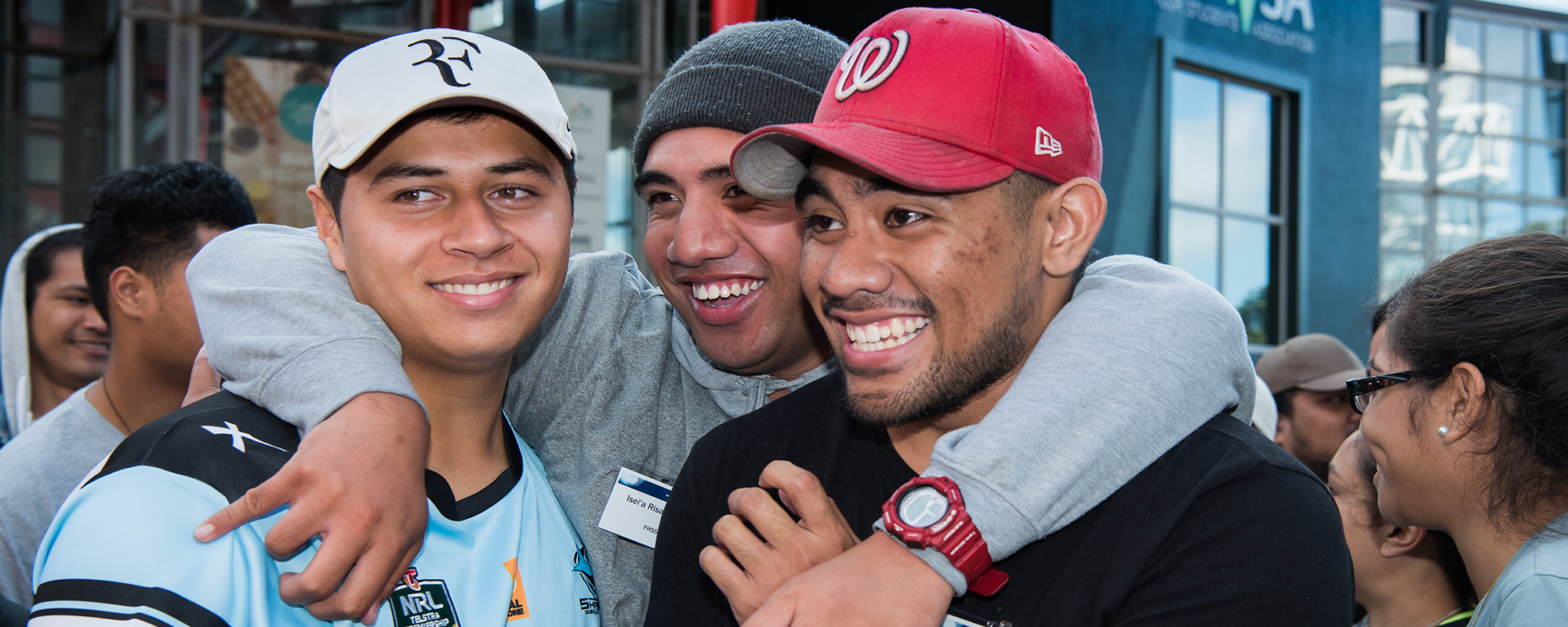 Pasifika academic camp – three students smile together.