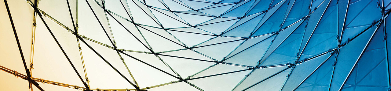 An undulating tessellation of glass triangles.