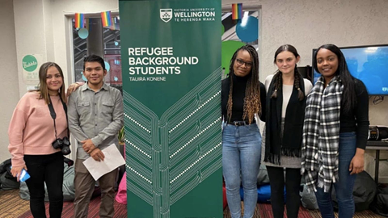 students with refugee background students sign