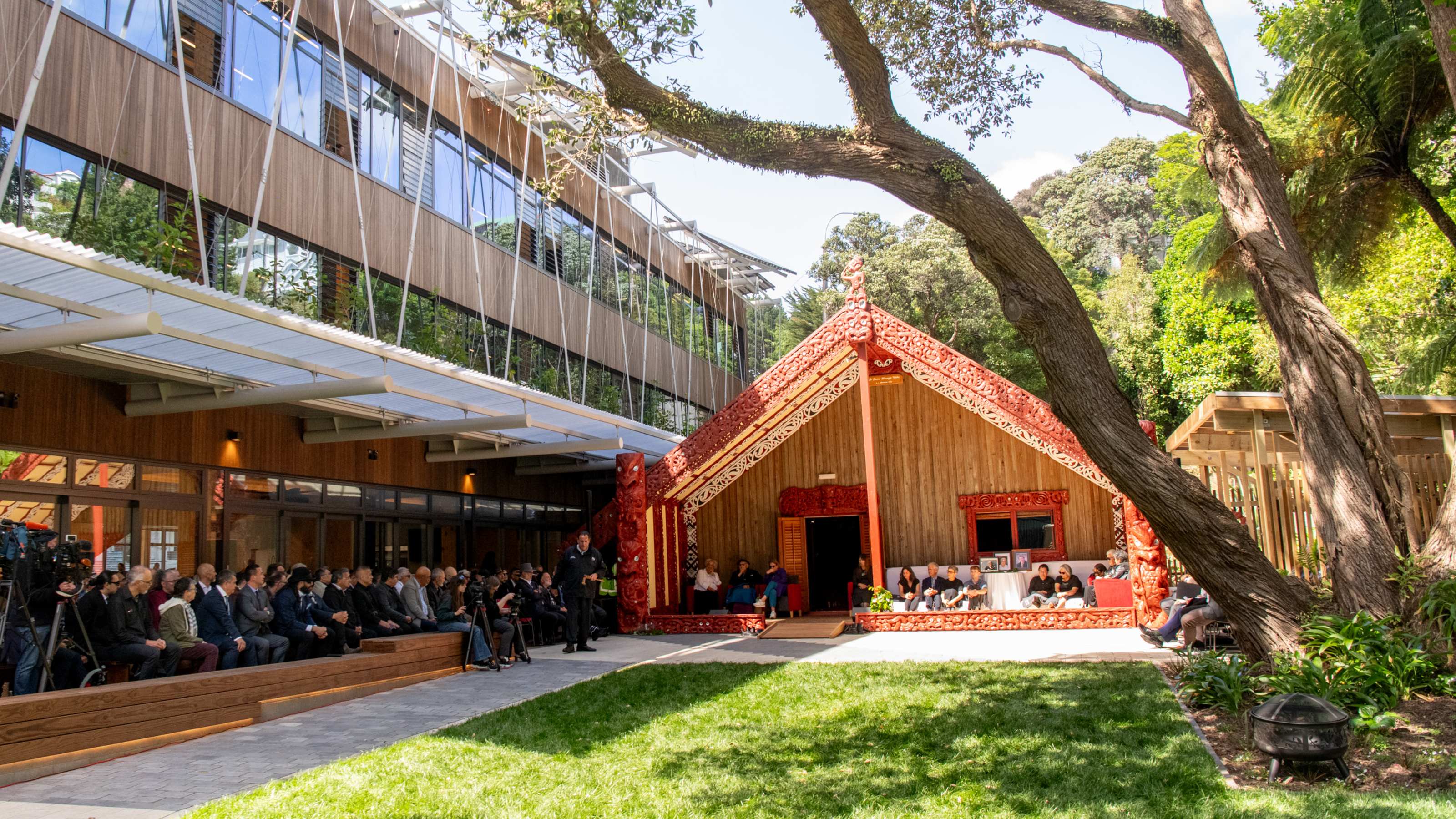 people gathered at the whare whakairo at the reopening day ceremony
