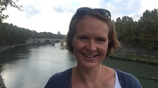 Dr Sally Hill in Rome, overlooking the river Tiber, the Ponte Sisto and the dome of St Peter's