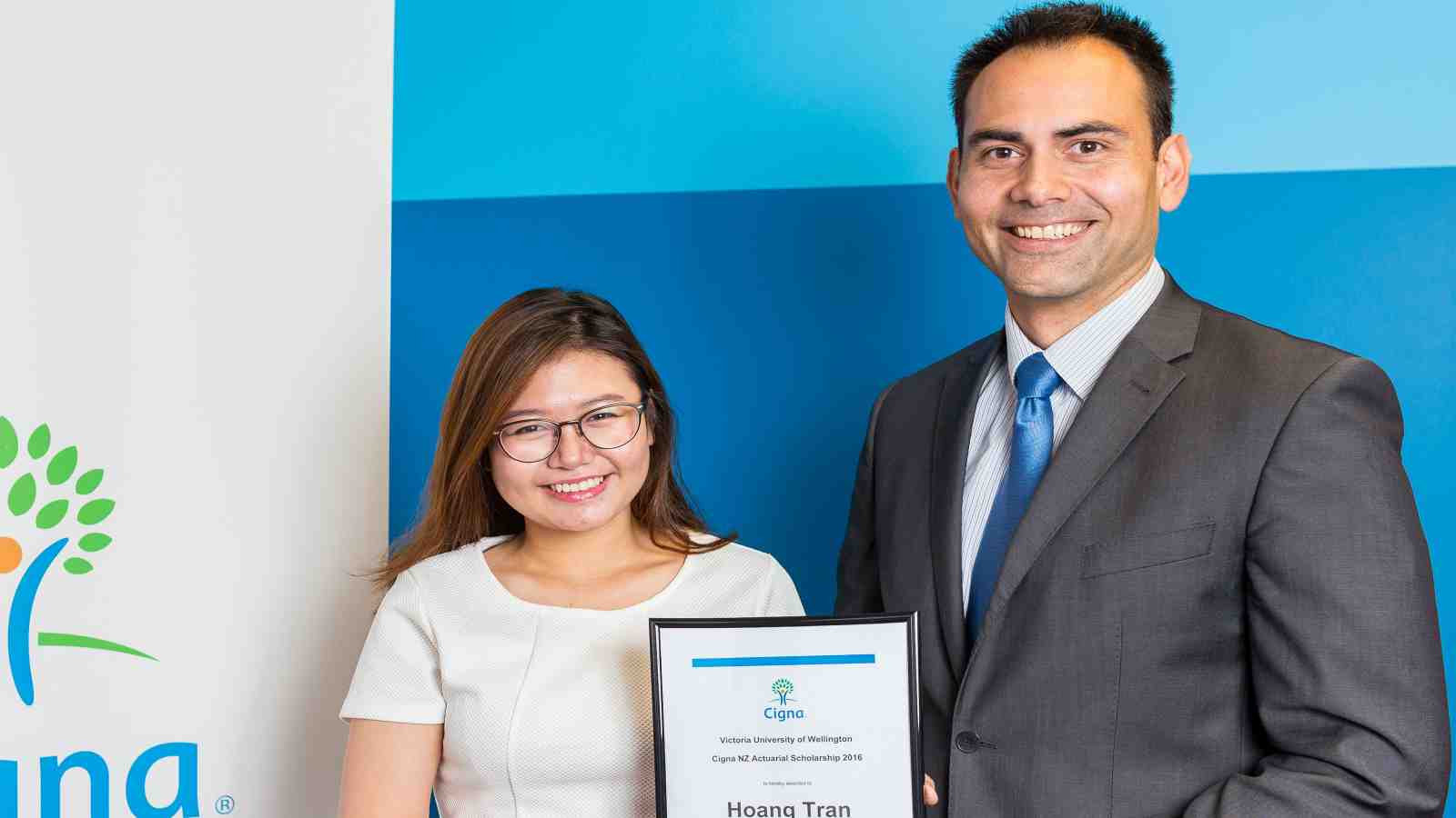 Scholarship winner Hoang Tran receives her award from Cigna New Zealand's Head of Actuarial Nathan Thomas