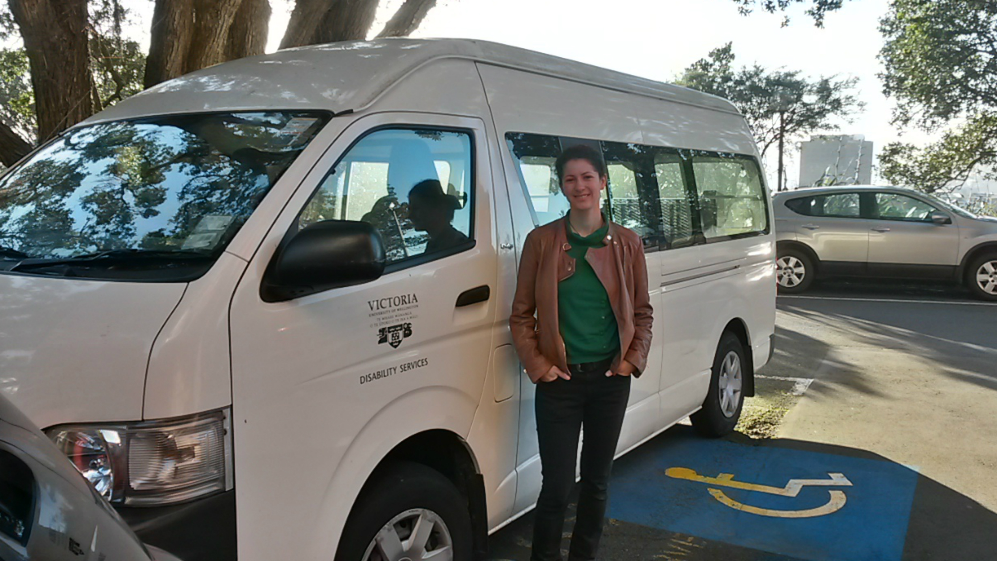 Maike standing in front on a white van