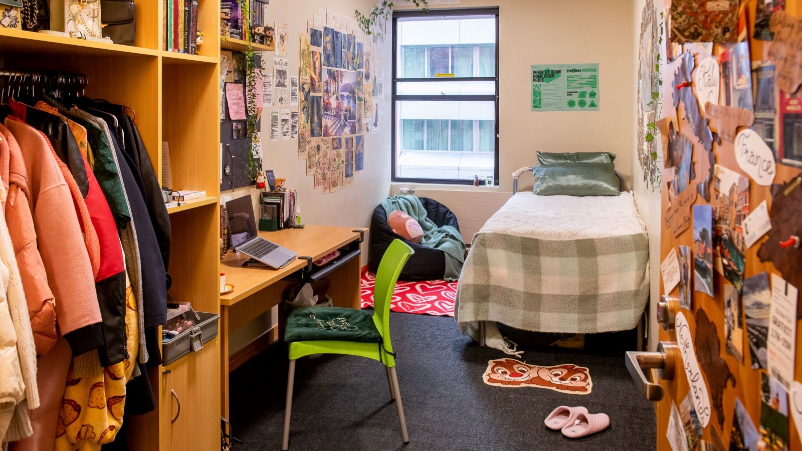 Single room at Joan Stevens Hall, with a bed, desk and chair, and wardrobe unit.