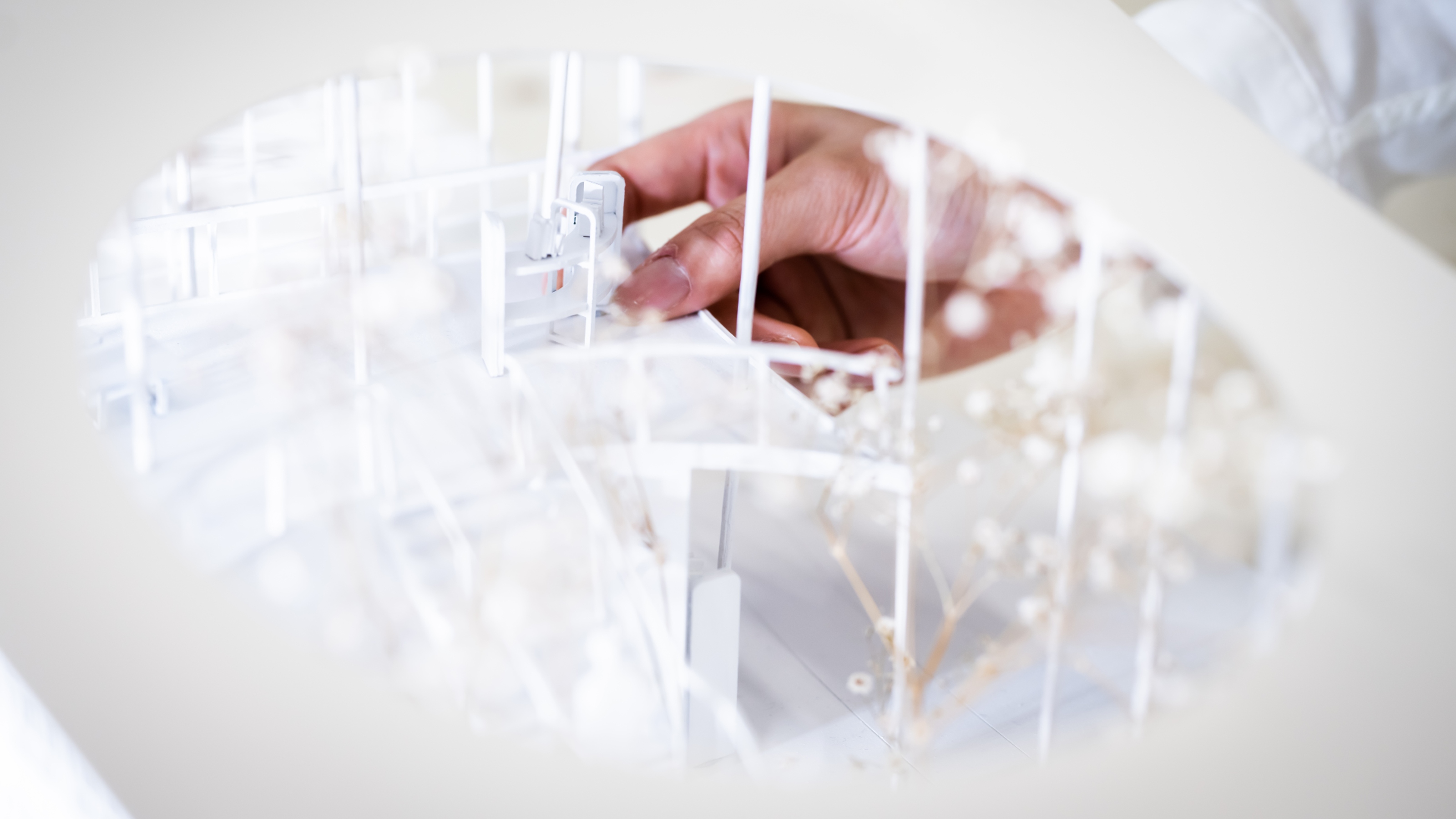 Zoomed in shot of inside of architectural model looking through the top of the model with a hand