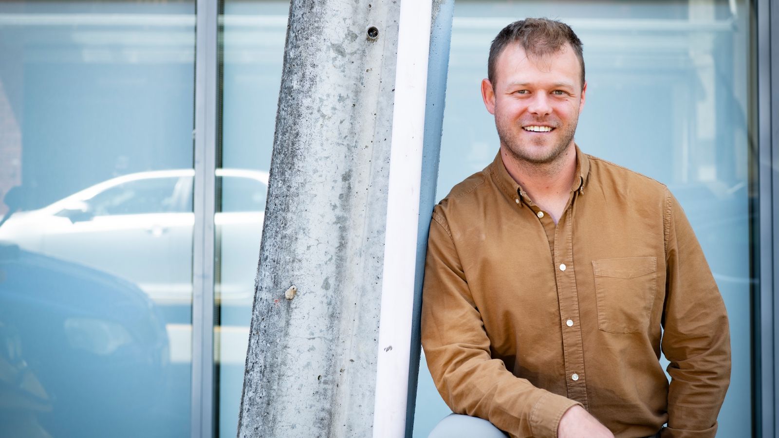 David Batchelor smiling to the camera and leaning to a lamp post