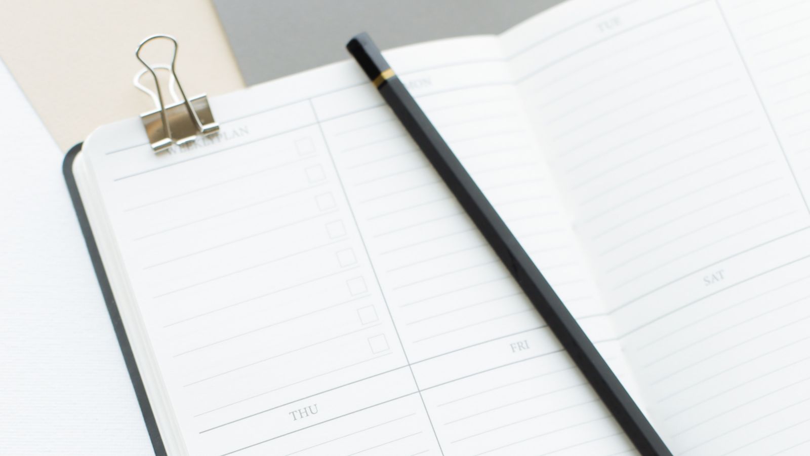 Opened diary with pencil placed on top