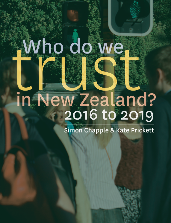 The cover of Who do we trust in New Zealand, with blurred people and a traffic light