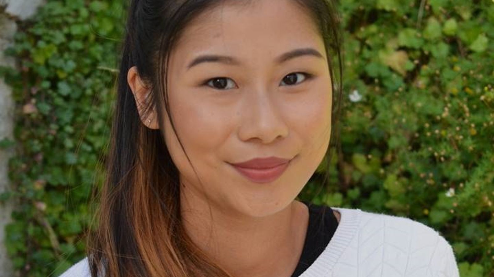 Head and shoulders portrait of Sarah Ky smiling at the camera.