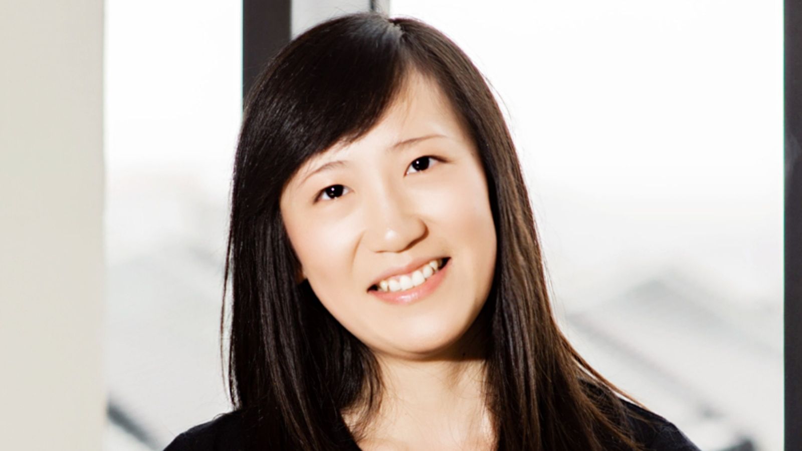 Head and shoulders portrait of Selina Li smiling at the camera.