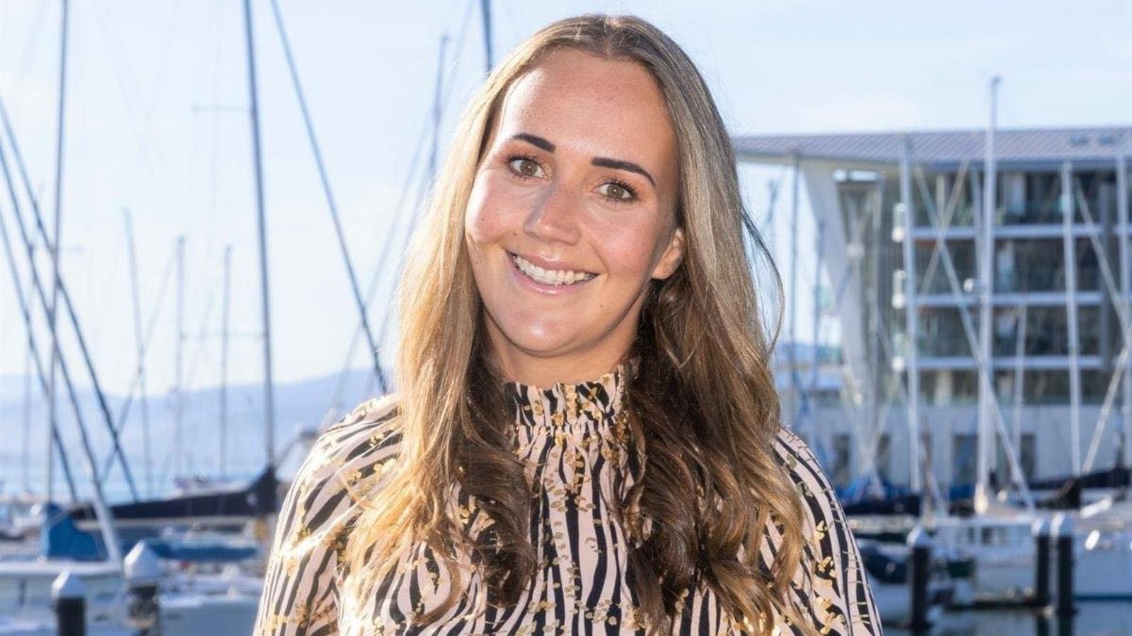 Head and shoulders portrait of Nikki Everton in front of a marina