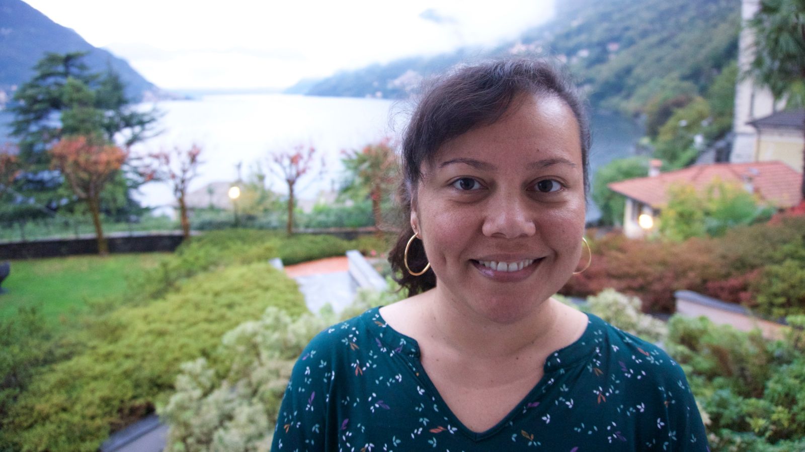 Head and shoulders photo of Emelihter Kihleng in front of greenery and water