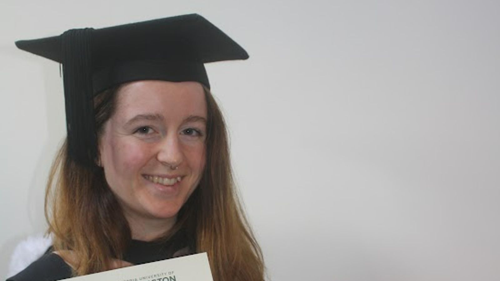 A head and shoulder picture of Marney Edwards wearing a graduation gown and cap.