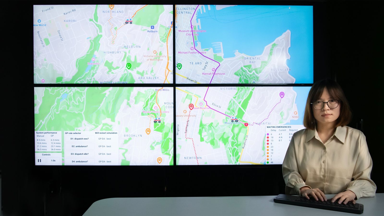 Woman in front of multi-screen display of town map