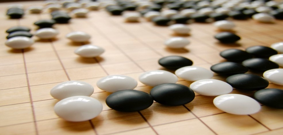 image of go board with black and white playing pieces