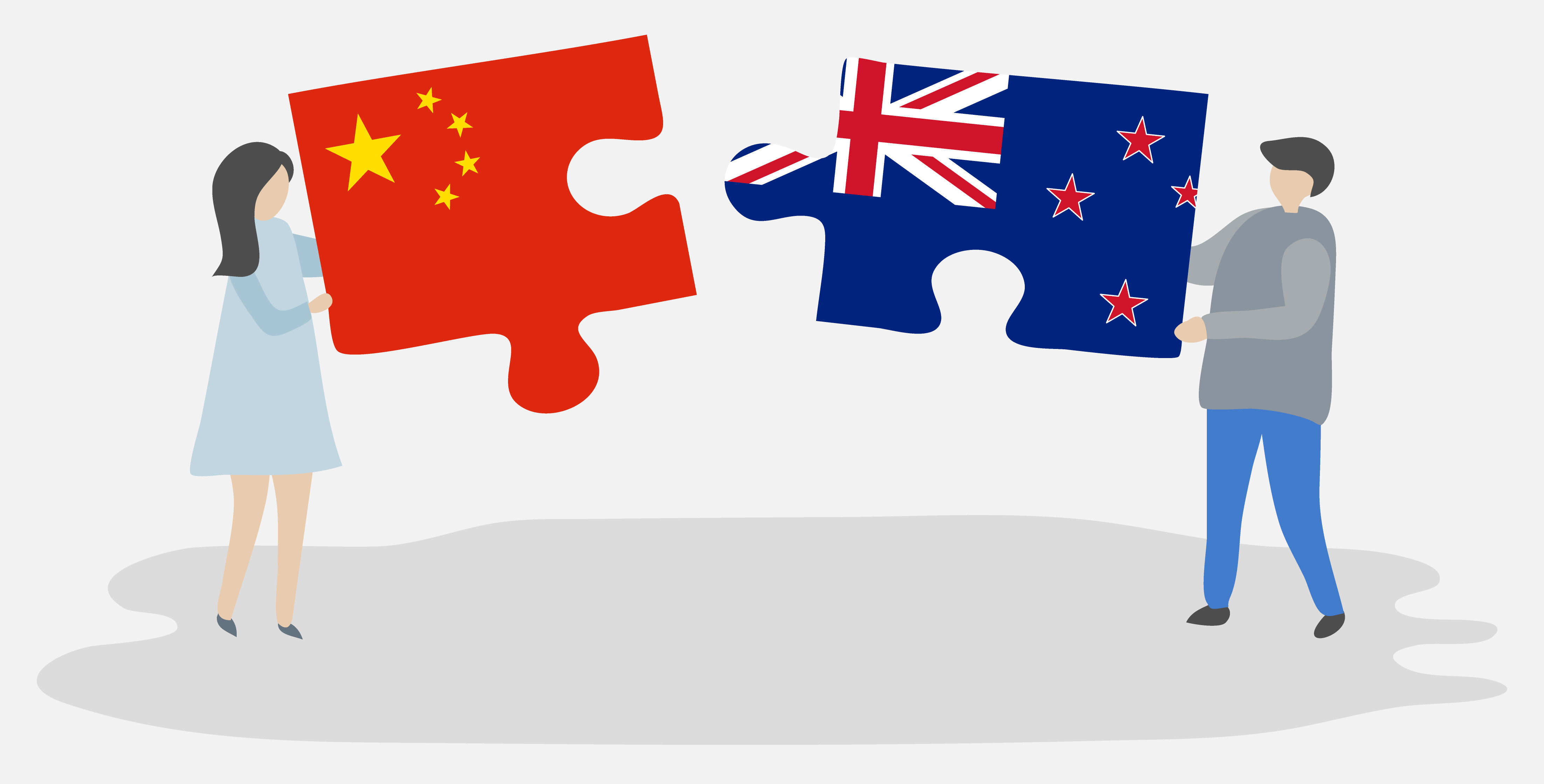 Image of two people holding a jigsaw puzzle with the flags of China and New Zealand