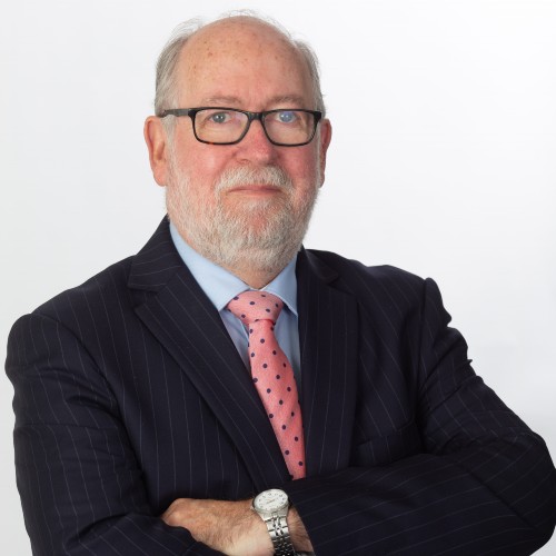 Judge John Walker with his arms crossed looking at the camera