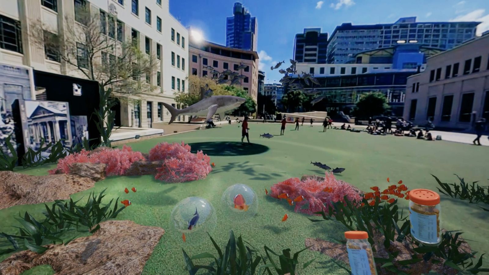 CG augmented image of Wellington civic centre with overlaid images of fish, bubbles, and jars