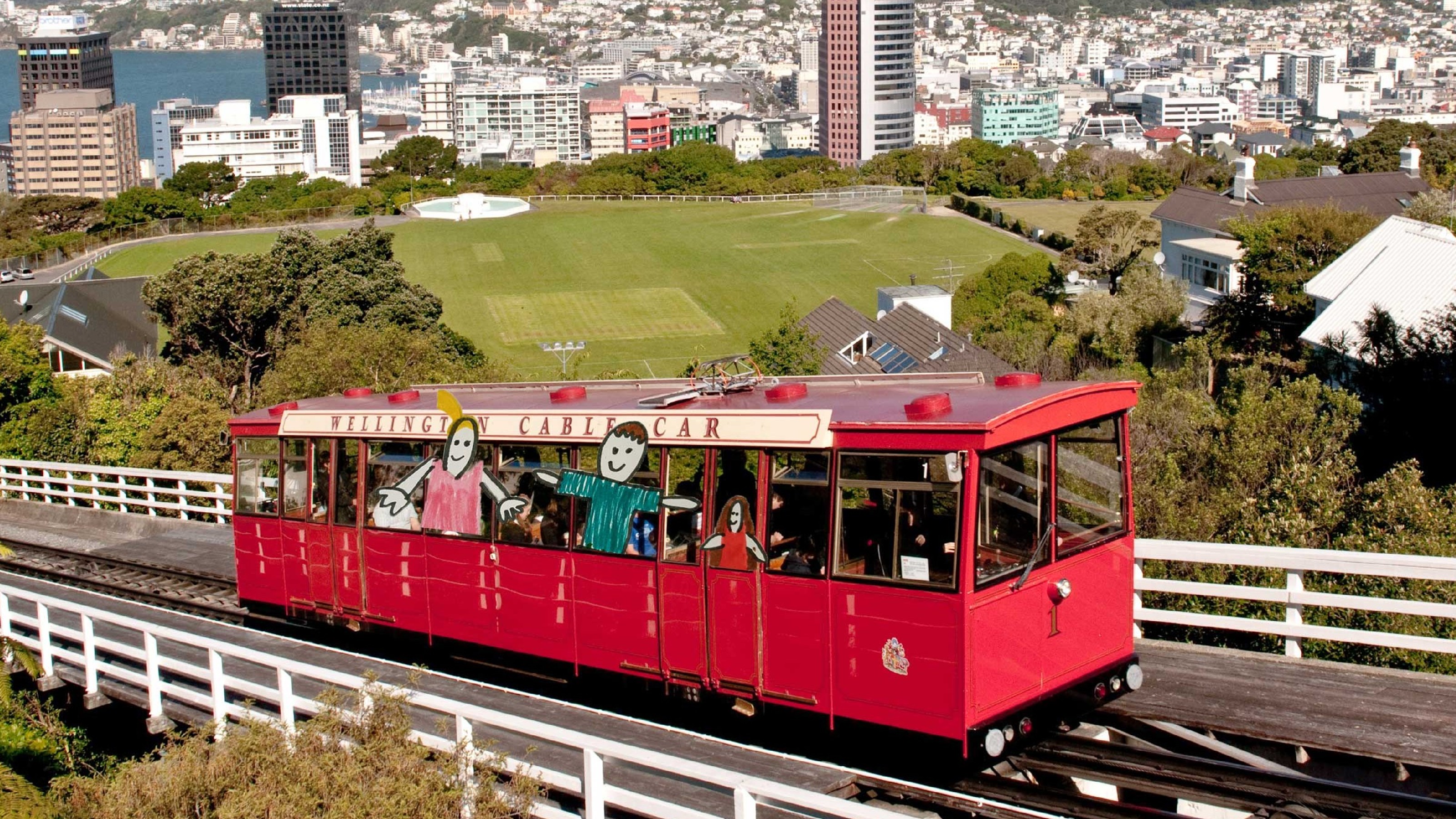 The Wellington Cable Car, overlaid with children's drawings of people in the window.