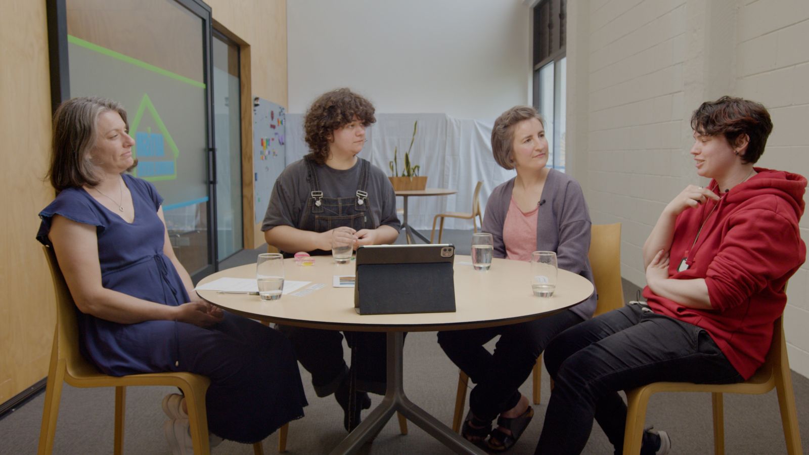 Four people in discussion around a table