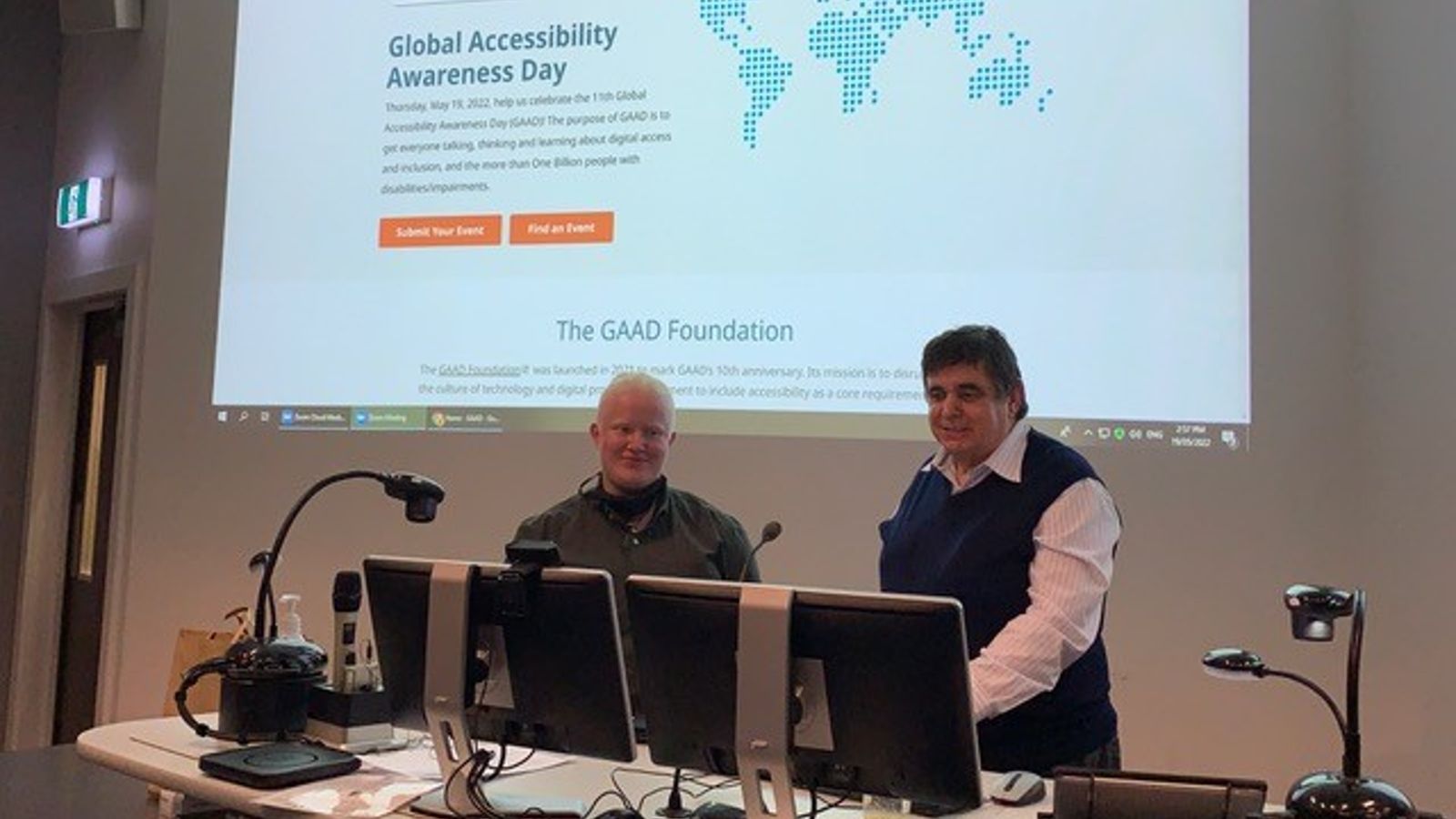 Bee Tapara and Thomas Bryan presenting the GAAD website on a projector during their guest lecture