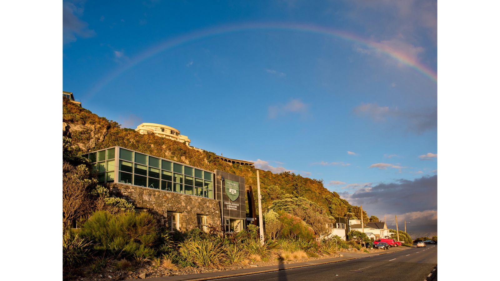 Exterior shot of Coastal Ecology Laboratory with rainbow in sky