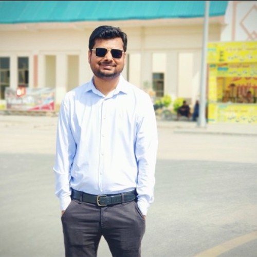 Pakistani man wearing a suit with black sunglasses.