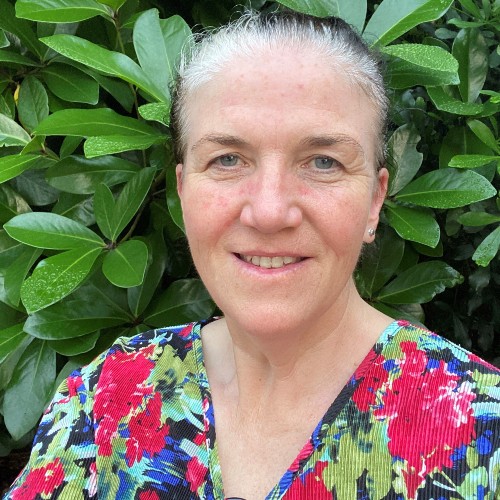 Woman with white hair smiling. 