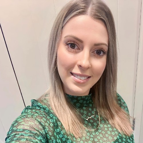 Woman with blonde hair smiling.