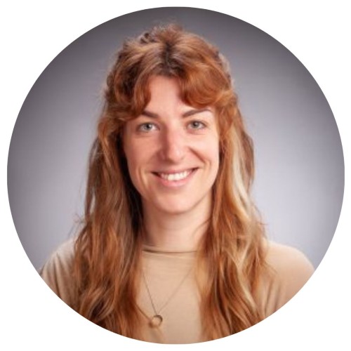 Woman with ginger long hair smiling. 
