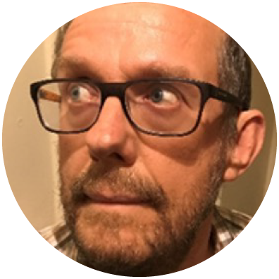 Man with glasses looking to the right. 