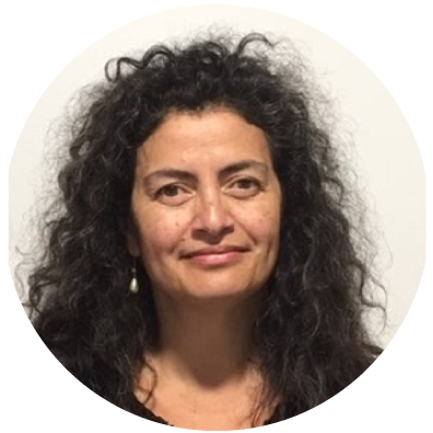 Woman with dark curly hair smiling. 