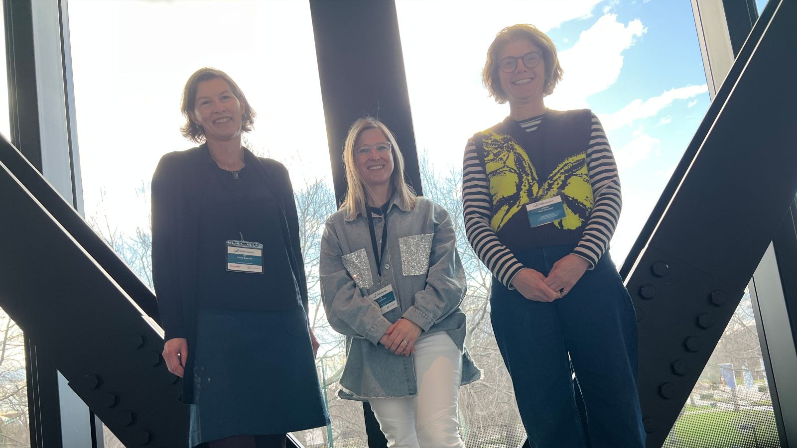 Flagship team standing in front of a window