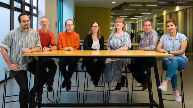 A group of eight people seated at a table.
