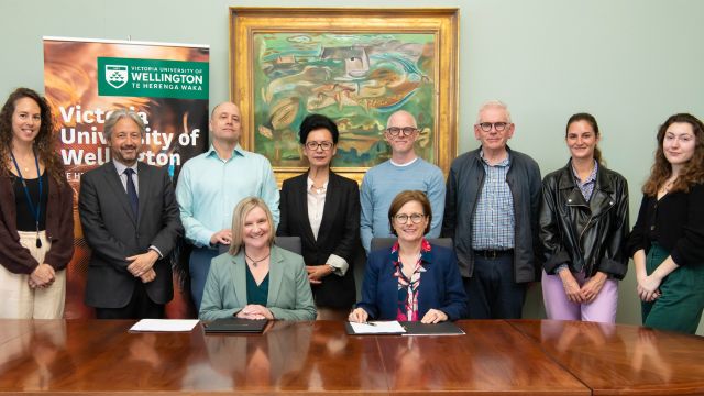 Professor Leggott and Ambassador Beau and others sign the MOU