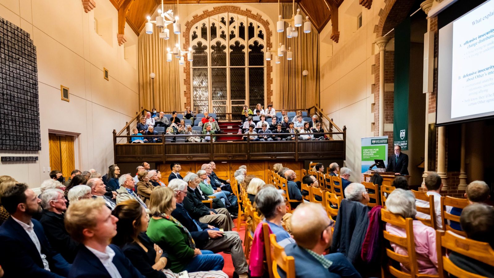 A crowd of people listening to a lecture in the Hunter Council Chamber