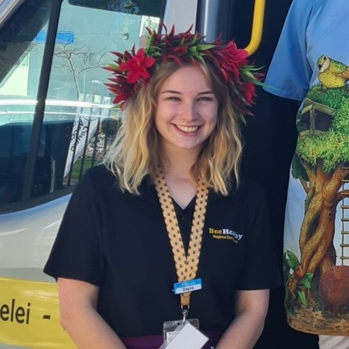 Dayna posing for a photo and wearing a Pacific Island flower crown. 