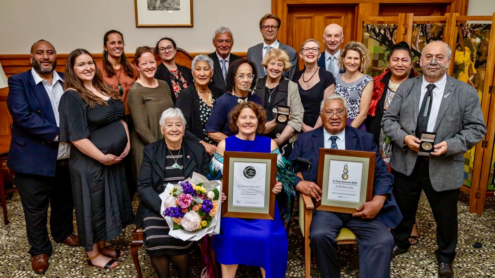 The centre team post for a photo with their awards at government house