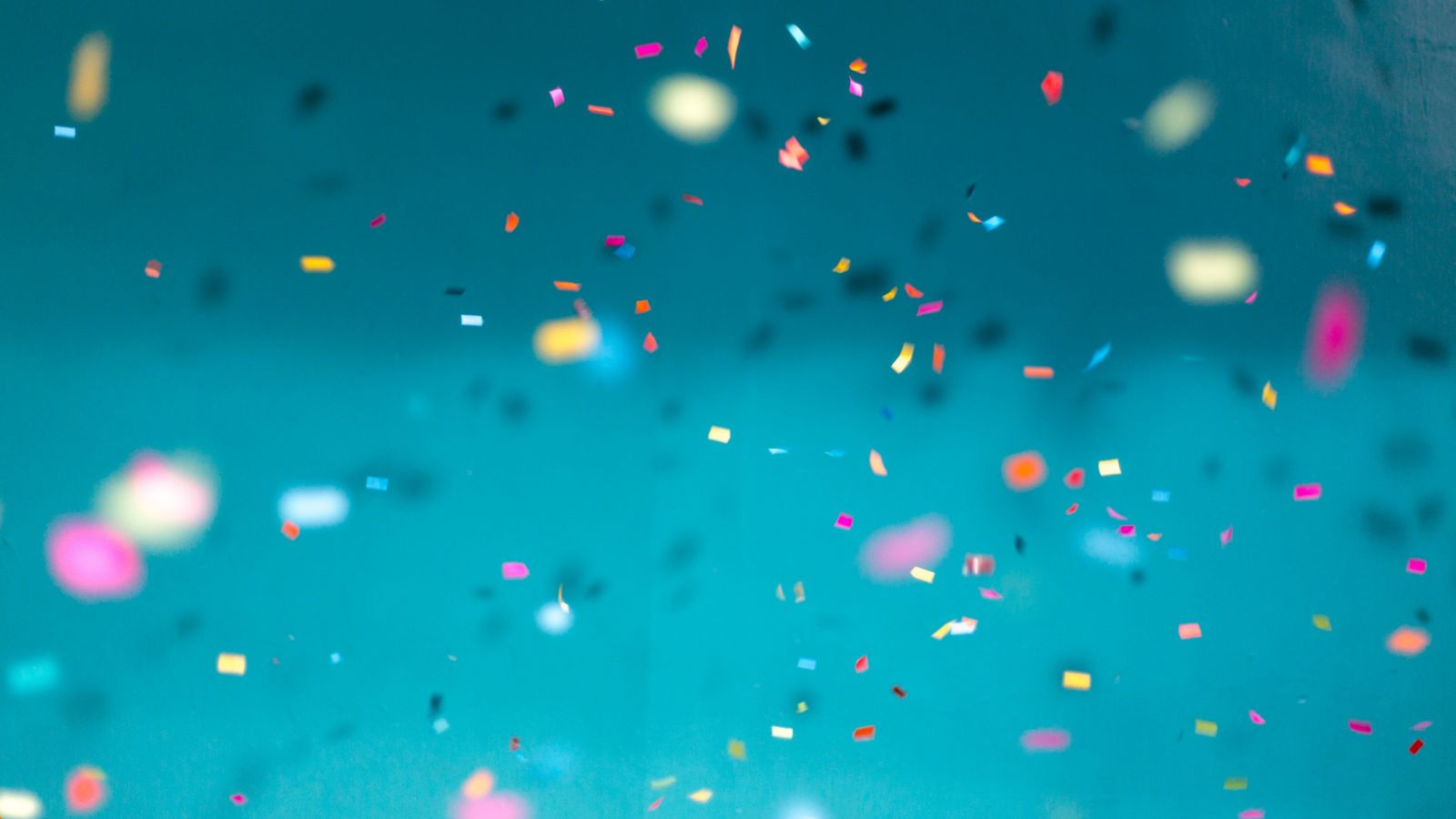 Confetti falling against a blue background