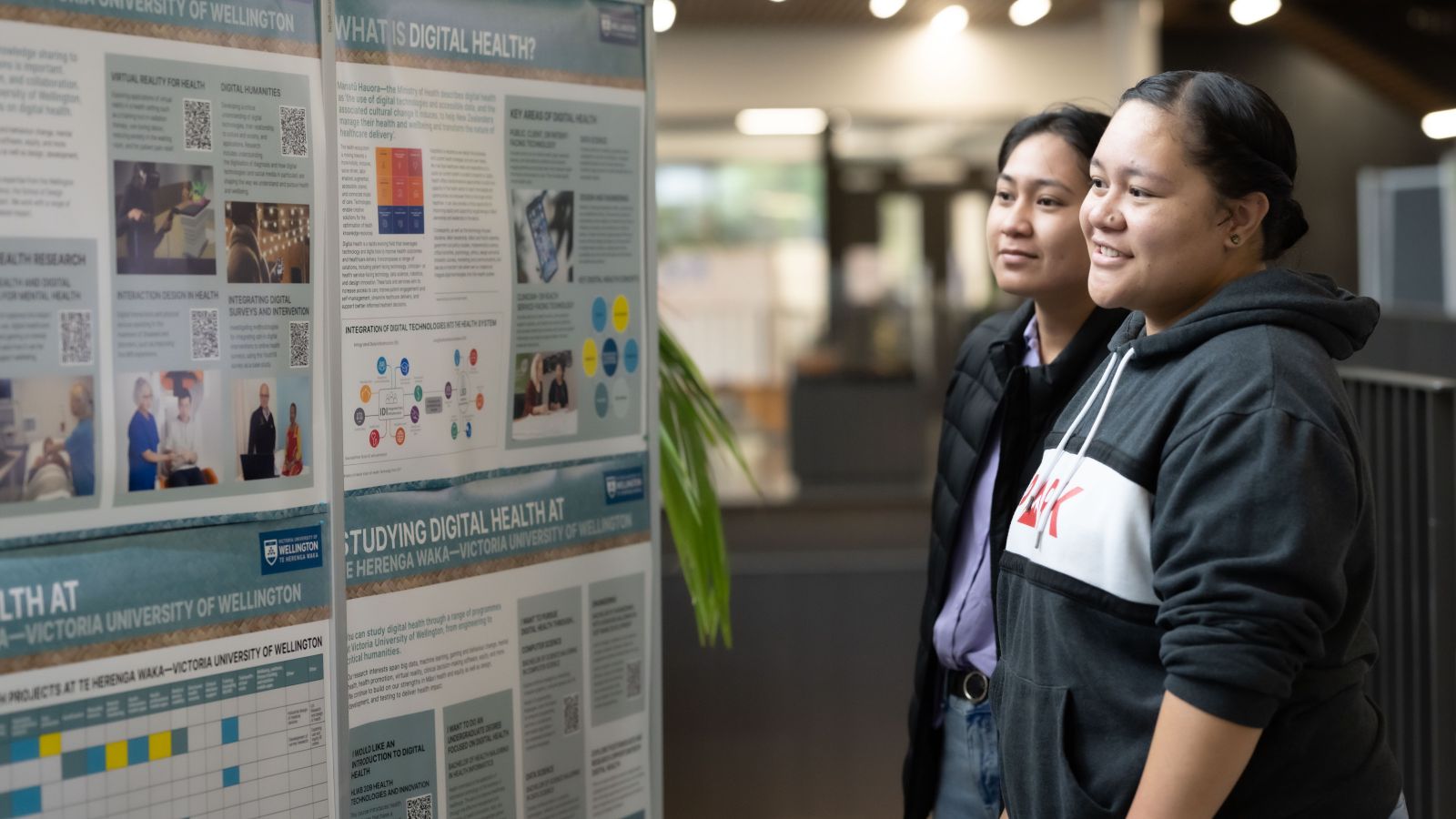 Two students read posters about digital health.