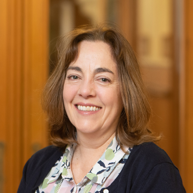 Woman with a short brown bob smiling