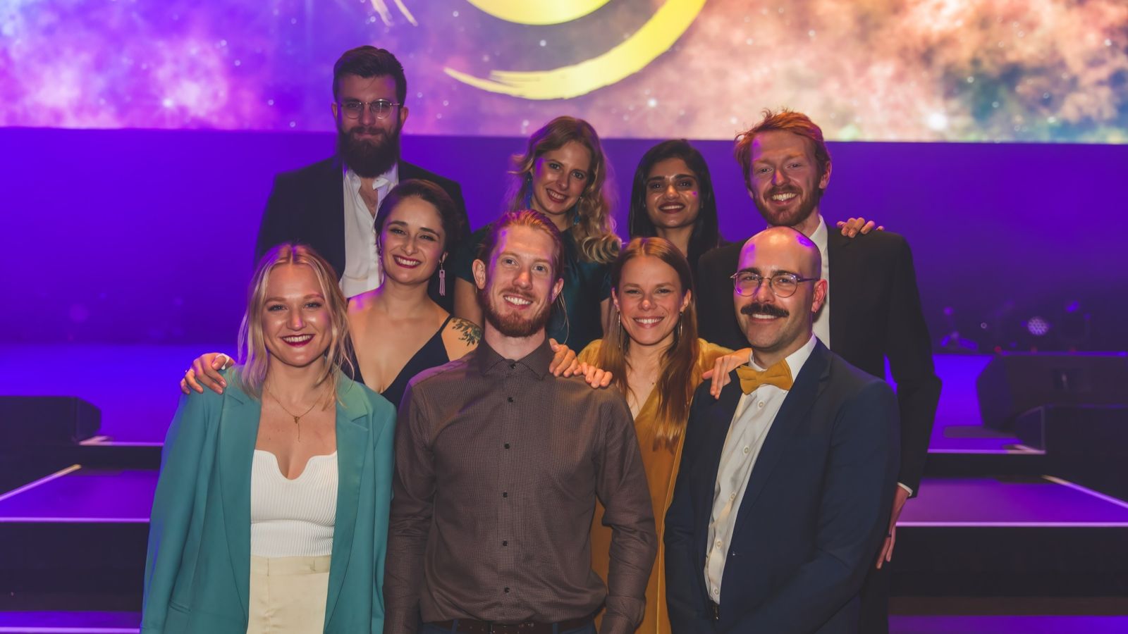 group of adults dressed up with glamourous background