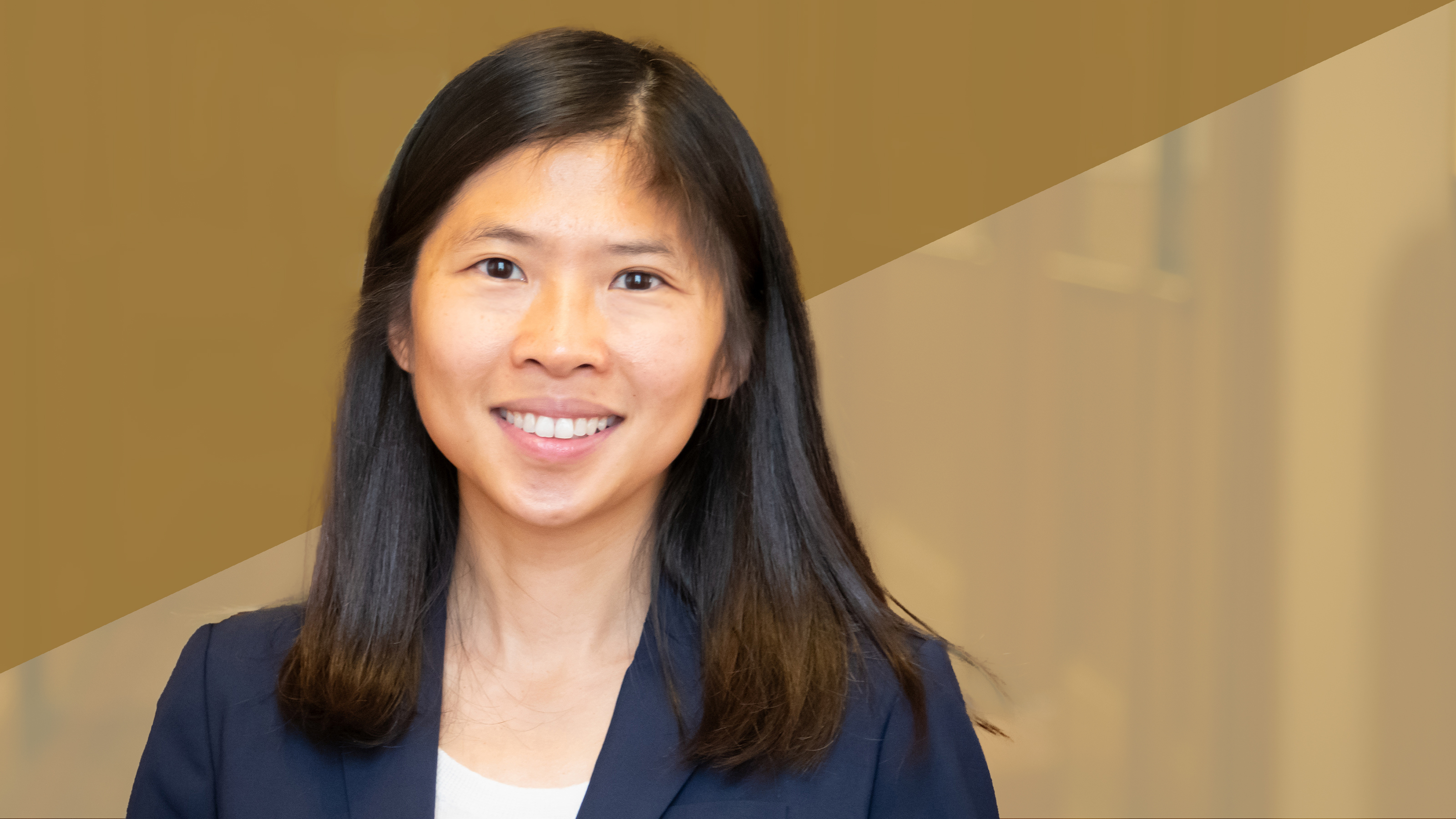 A profile of a woman in a black jacket, taken from the shoulders up. 