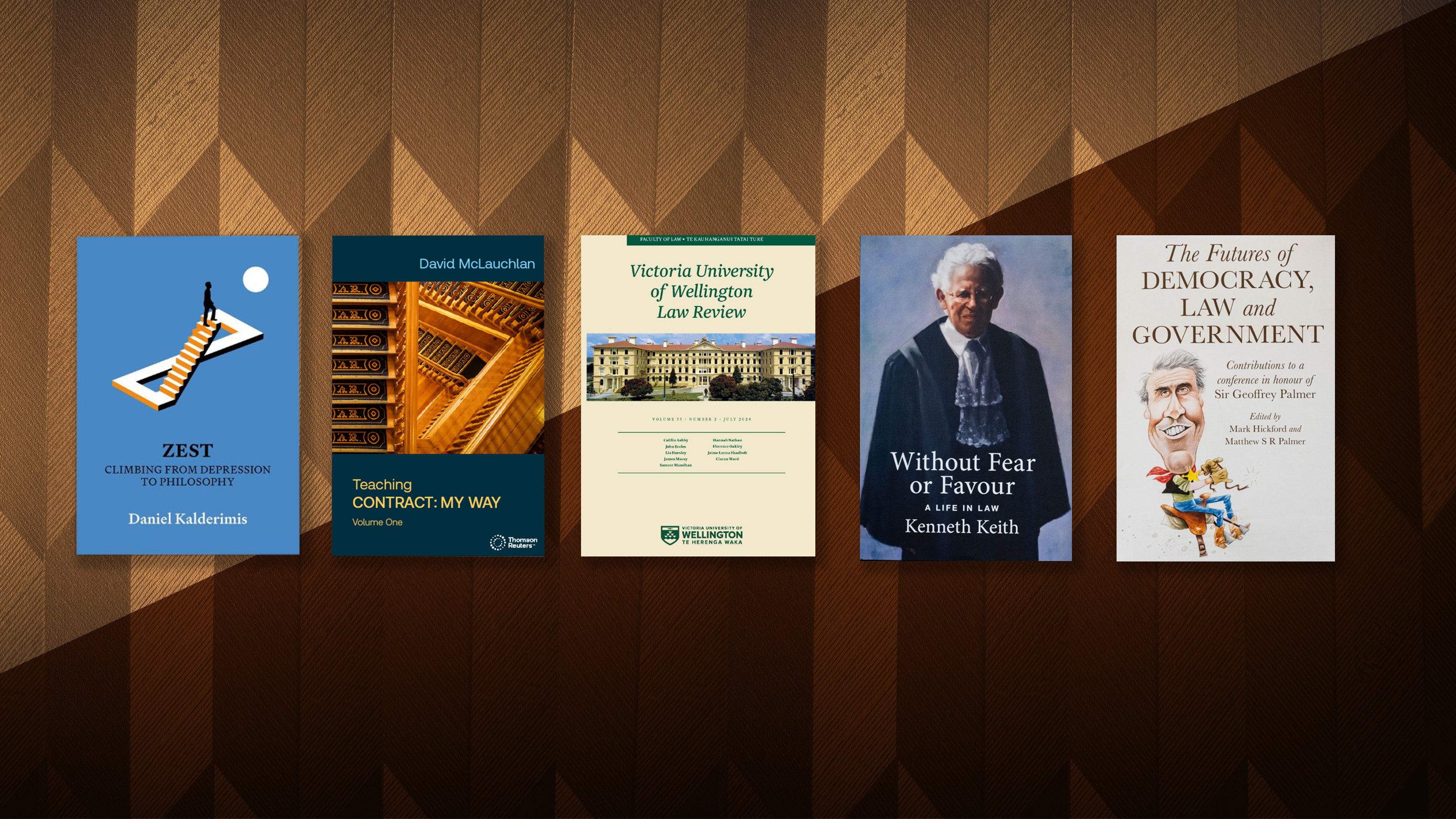 A row of five books against a brown background. 
