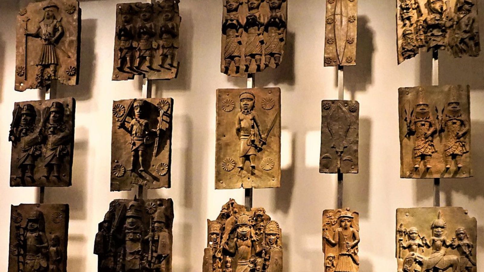 worked relief images in bronze exhibited in a group of 20 hung on a wall in the british museum