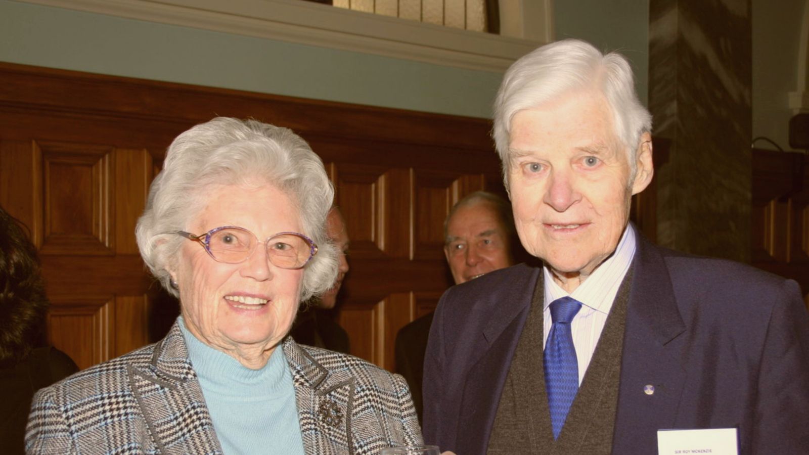 Two smartly dressed older people, who are Lady Shirley and Sir Roy McKenzie.